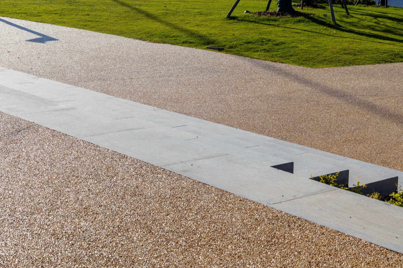 Resin bound stone driveway — warm gold blend with paver edge