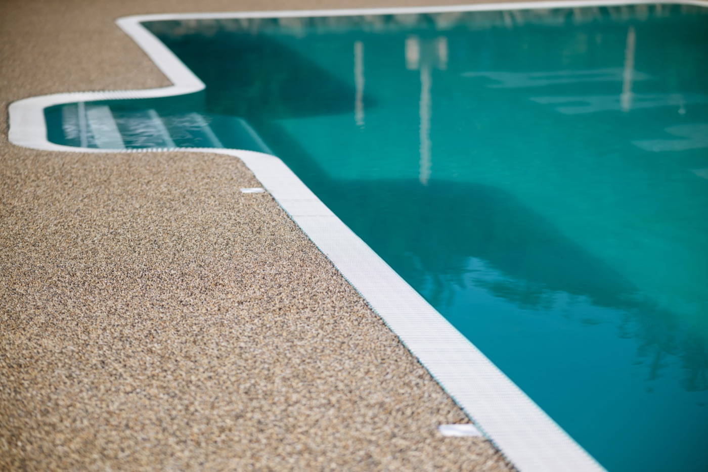 Resin bound stone pool surround — coastal sand blend